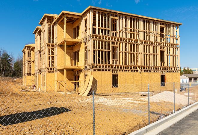 a construction site enclosed by temporary chain link fences, ensuring safety for workers and pedestrians in Asbury IA